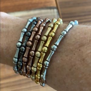 Set of 7 metal Lia Sophia stretch bracelets.